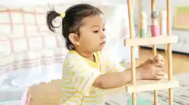 Preschool child playing with people figures