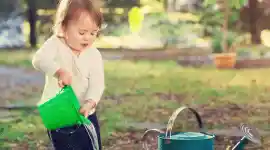 a child with a watering pot