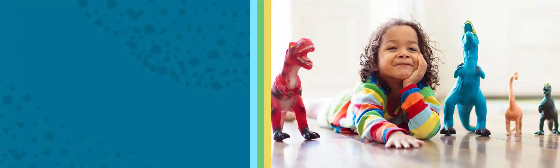 Preschool child playing on floor with dinosaur figures