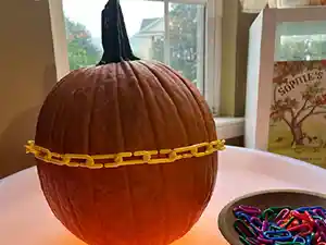 Orange pumpkin with links measuring