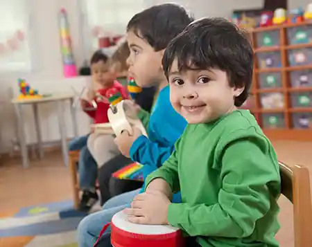 young children playing instruments in a classroom