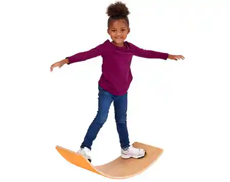 Young girl playing and balancing on sensory board