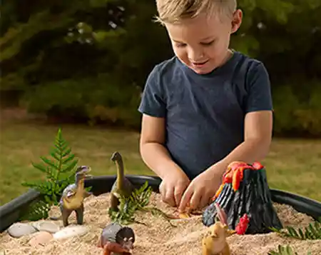 A child enjoying sensory play outside with in a Tuff Tray from Becker&rsquo;s School Supplies