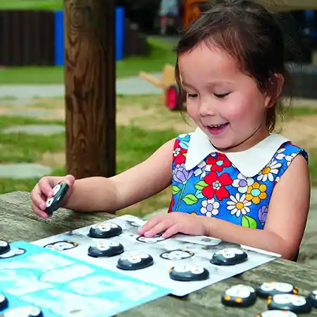 Girl playing with coding penguins